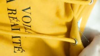 Home daytime striptease in a yellow hoodie. Close-up