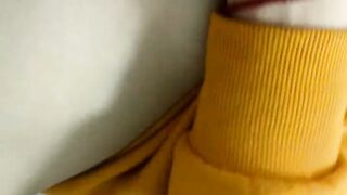 Home daytime striptease in a yellow hoodie. Close-up