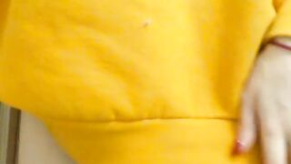 Home daytime striptease in a yellow hoodie. Close-up