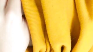 Home daytime striptease in a yellow hoodie. Close-up