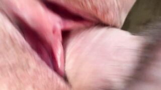 Cum flows from a meaty, swollen and fucked up pussy. Close-up.