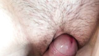 Cum flows from a meaty, swollen and fucked up pussy. Close-up.