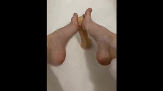 Sexy girl in the bathroom masturbating with her feet and herself