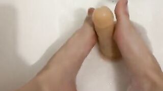 Sexy girl in the bathroom masturbating with her feet and herself