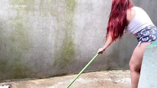 Maid in pajamas cleaning the yard