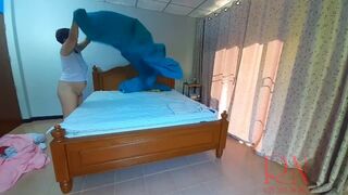 Nudist housekeeper Regina Noir makes the bedding in the bedroom. Naked maid. Naked housewife. c2