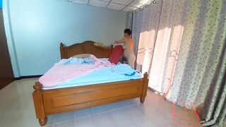 Nudist housekeeper Regina Noir makes the bedding in the bedroom. Naked maid. Naked housewife. c2