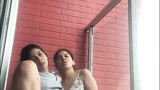 Hot girls film themselves kissing and touching each other on the balcony