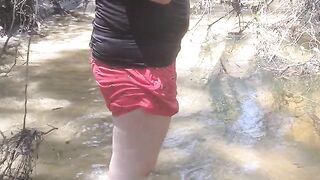 Cute long hair girl on her knees looking for shells to collect in popular spring creek part 2