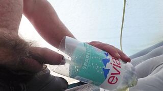 Pissing in a bottle in a tent while camping