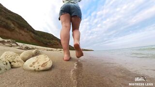 Barefoot Girl Walks Over The Summer Seashore