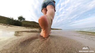 Barefoot Girl Walks Over The Summer Seashore