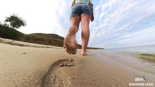 Barefoot Girl Walks Over The Summer Seashore