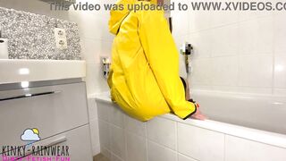 girl in yellow rubber raincoat playing with a rubber duck Teaser