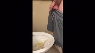 Sexy tattooed DILF peeing in a public bathroom