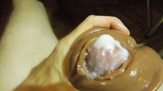 A man fondles a rubber vagina and cum in it.