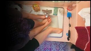 18 year old washing feet in sink