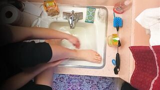 18 year old washing feet in sink