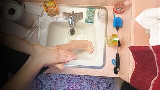 18 year old washing feet in sink