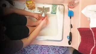 18 year old washing feet in sink