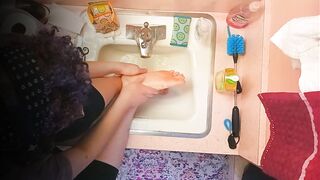 18 year old washing feet in sink