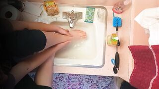 18 year old washing feet in sink