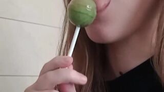 Cute brunette playing with her lollipop.