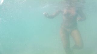 Naked, swiming at the sea