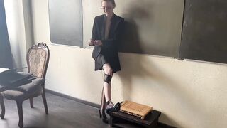 A strict teacher loves to wear high heels and play with them right in the classroom, from which her