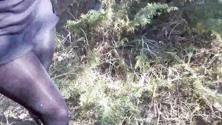 Walking on the Wood Wearing a Black Dress, Pantyhose and High Heels Ankle Boots