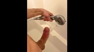 the guy washes the dick with a huge jet and cums