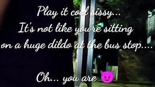 Sissy slut sitting on a huge dildo in public bus station at night while cars pass by