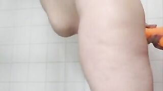 Orange dildo in the shower with Milf pawg